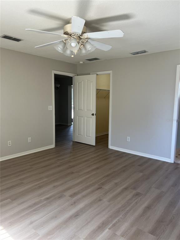 6035 Southwest 98th Street Road Ocala, FL 34476 - Photo 7 of 15 a view of an empty room with wooden floor
