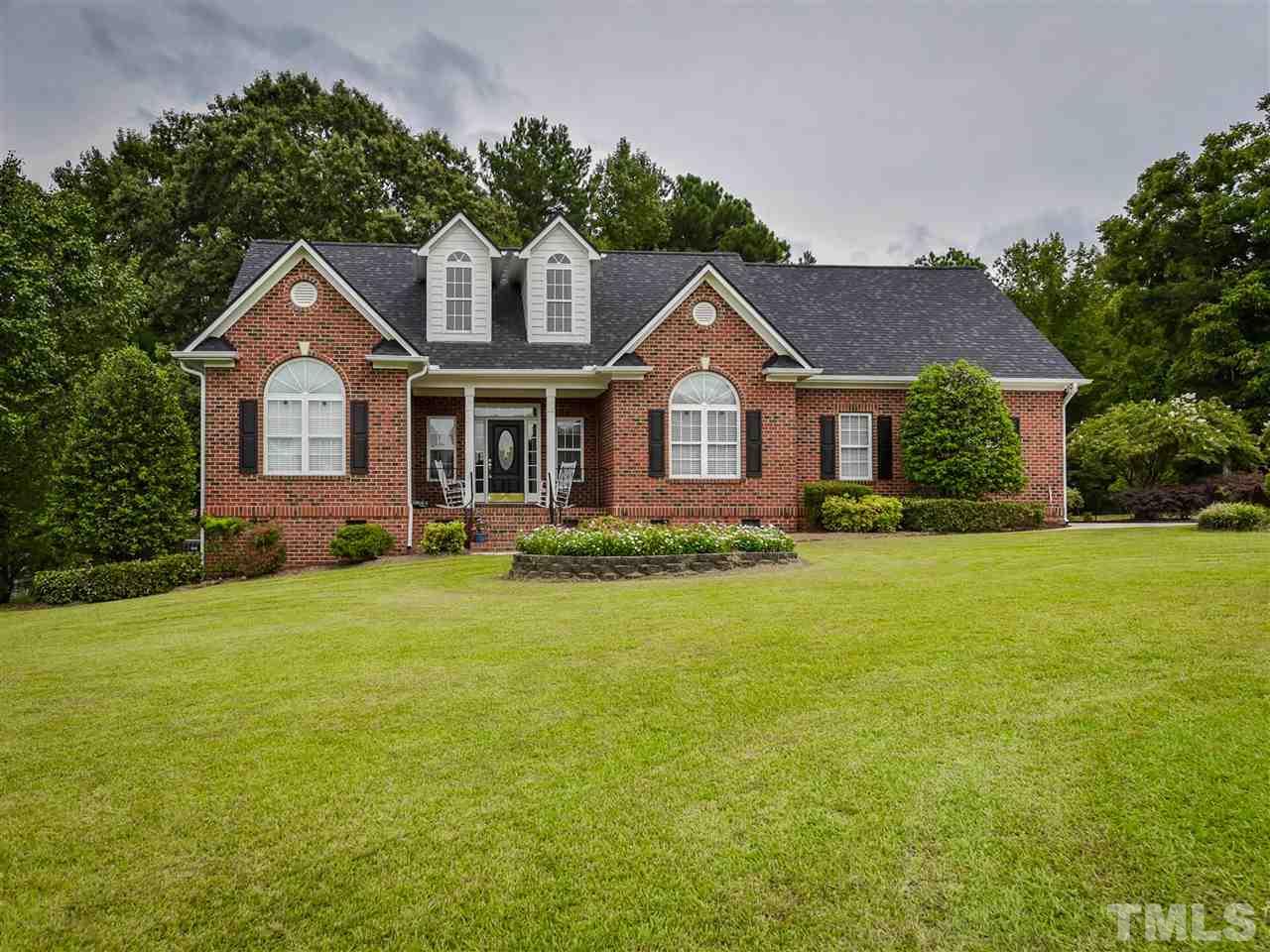6005 Maton Place Raleigh, NC 27603 - Photo 1 of 30 a front view of a house with a garden