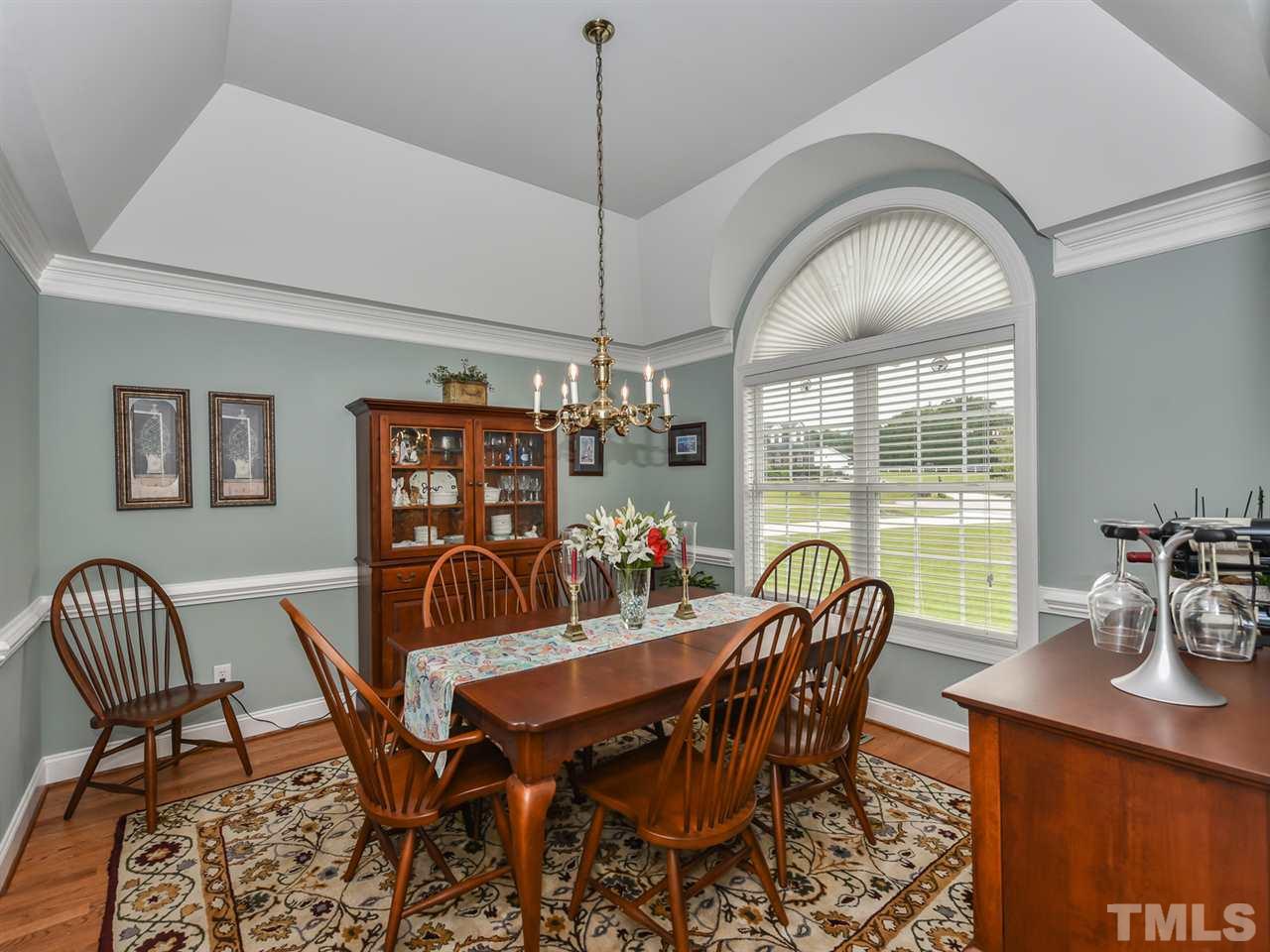 6005 Maton Place Raleigh, NC 27603 - Photo 11 of 30 a view of a dining room with furniture and chandelier