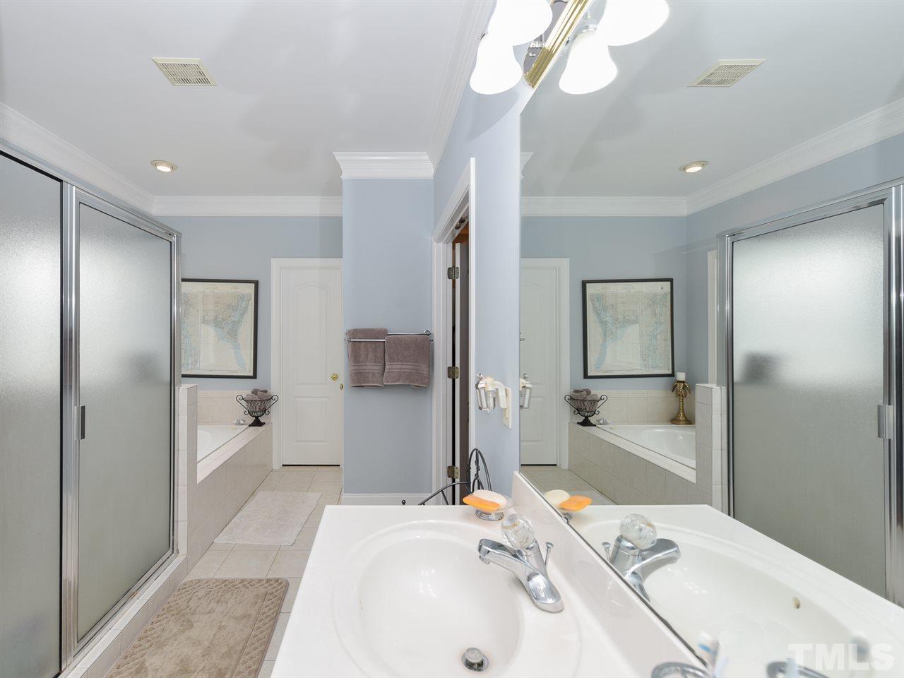 6005 Maton Place Raleigh, NC 27603 - Photo 15 of 30 a bathroom with a sink a toilet and shower