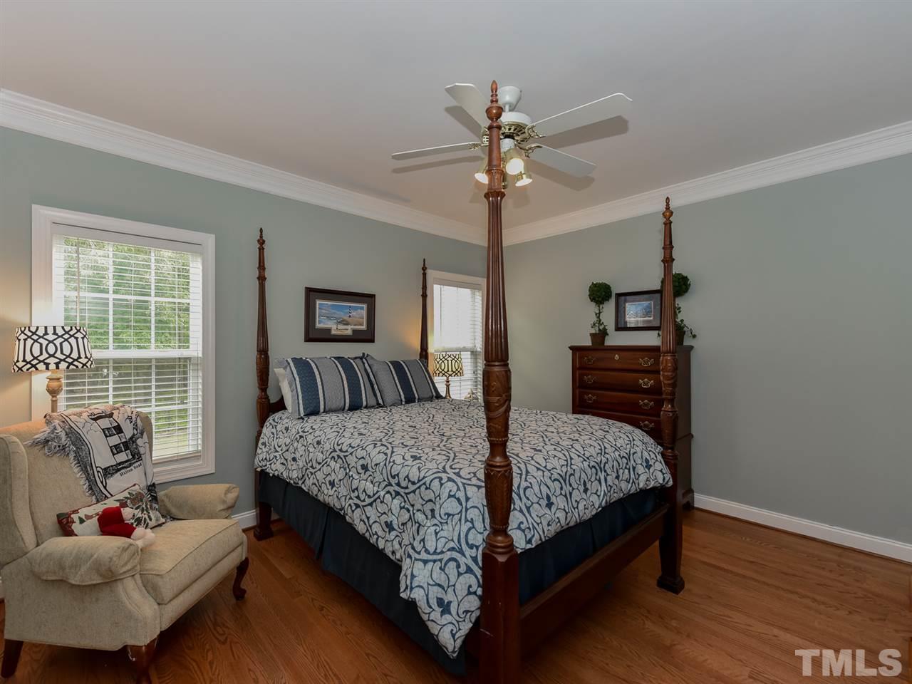 6005 Maton Place Raleigh, NC 27603 - Photo 18 of 30 a bedroom with a bed and wooden floor