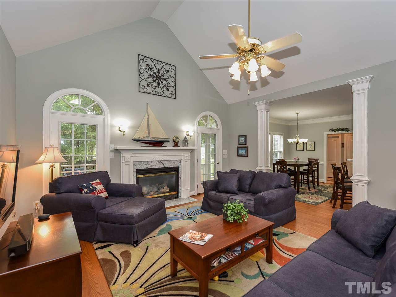 6005 Maton Place Raleigh, NC 27603 - Photo 3 of 30 a living room with furniture a fireplace and a large window