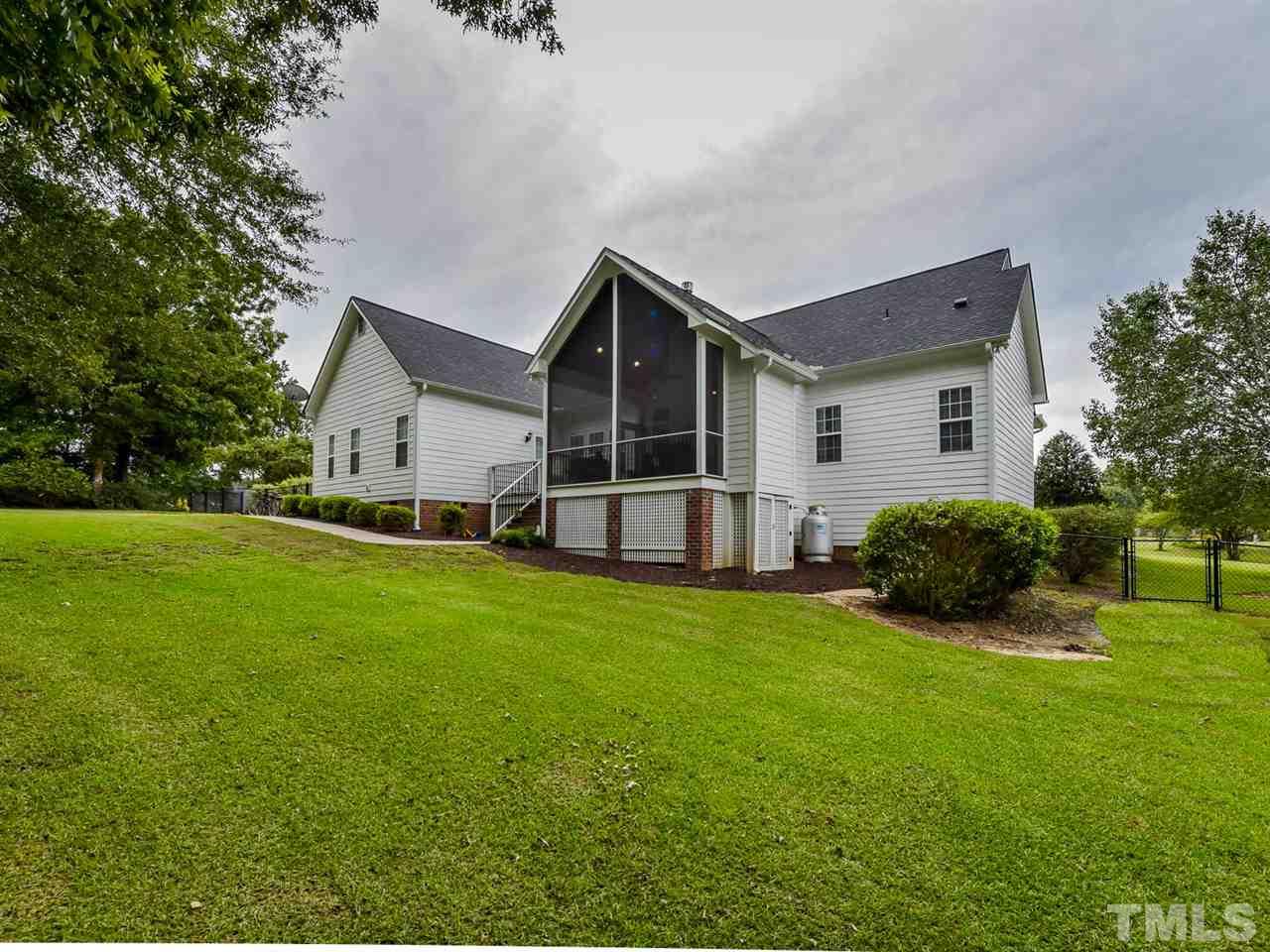 6005 Maton Place Raleigh, NC 27603 - Photo 23 of 30 a view of a house with backyard and garden
