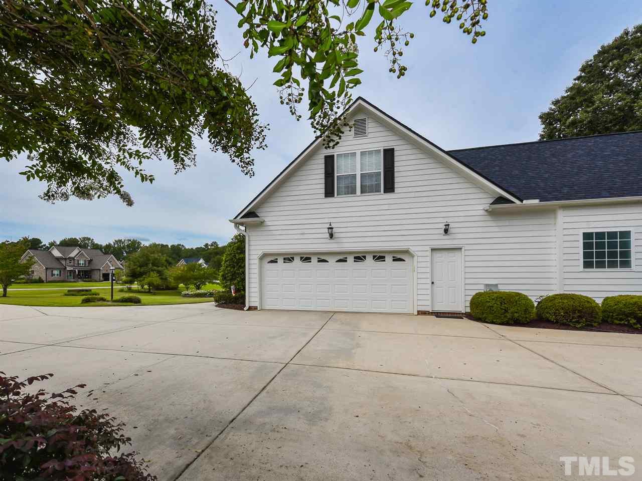 6005 Maton Place Raleigh, NC 27603 - Photo 28 of 30 a view of a house with a yard and potted plants