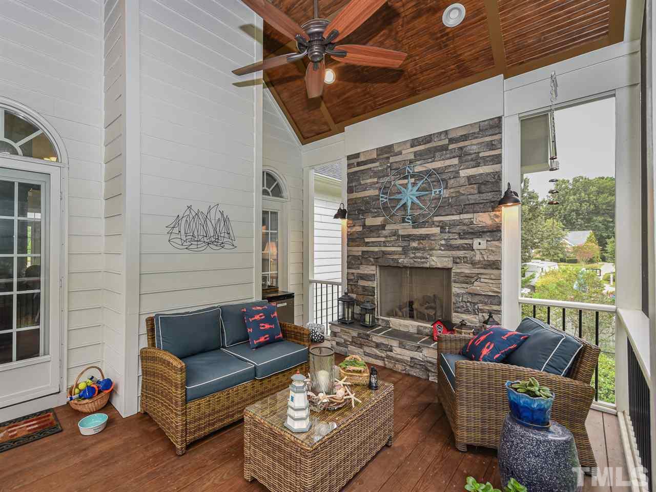 6005 Maton Place Raleigh, NC 27603 - Photo 6 of 30 a living room with furniture a fireplace and a flat screen tv