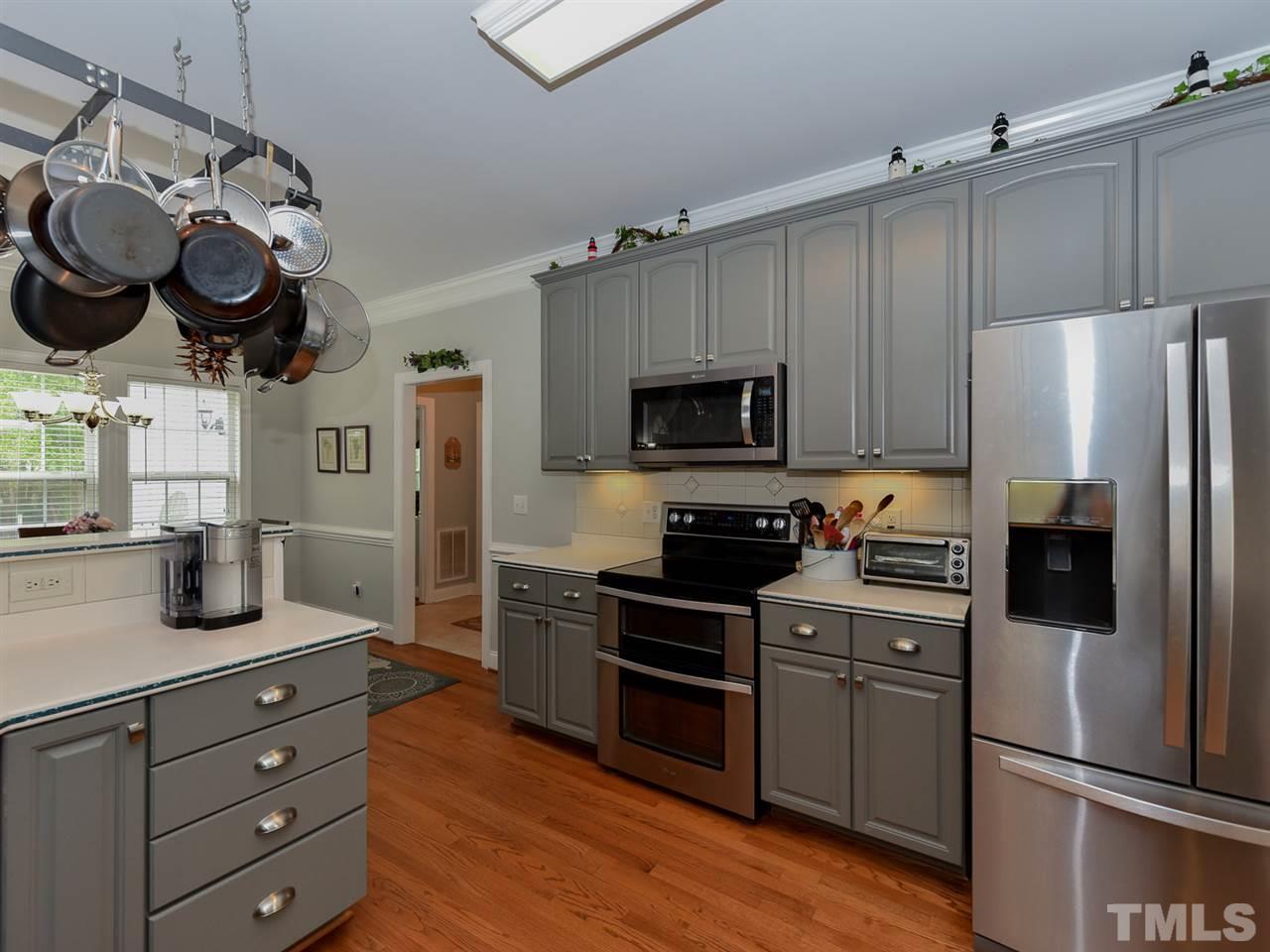 6005 Maton Place Raleigh, NC 27603 - Photo 8 of 30 a kitchen with a refrigerator and a stove top oven