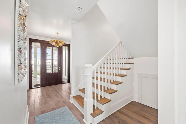 a view of a dining room and livingroom with furniture a flat screen tv and a large window