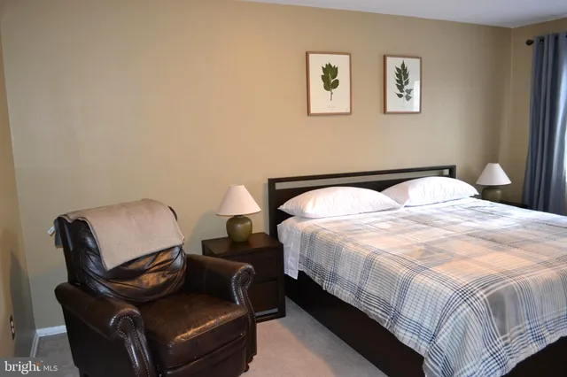 a bedroom with a bed and chair