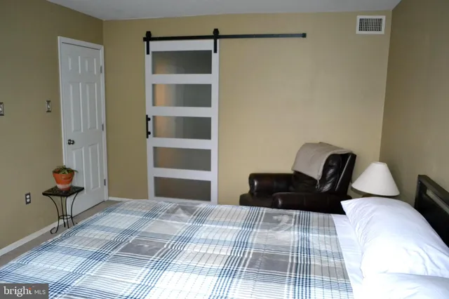 a bedroom with a bed and chair