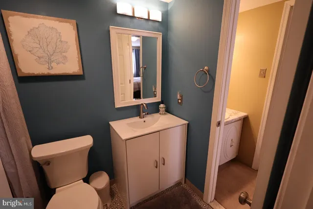 a bathroom with a toilet sink and mirror