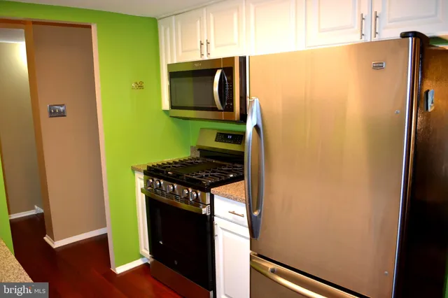 a kitchen with a refrigerator stove and microwave