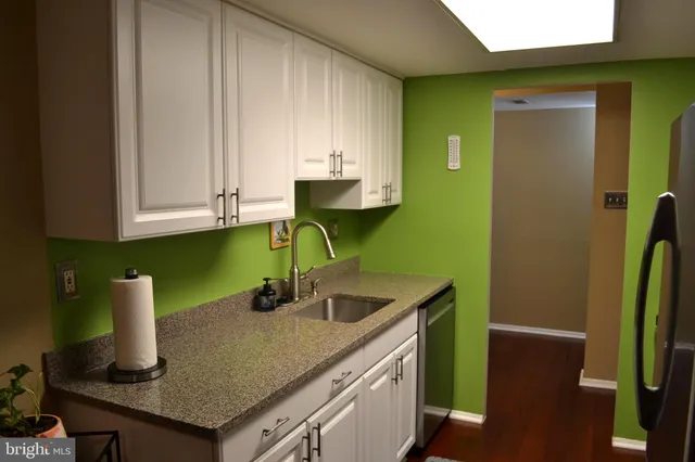 a kitchen with sink and cabinets