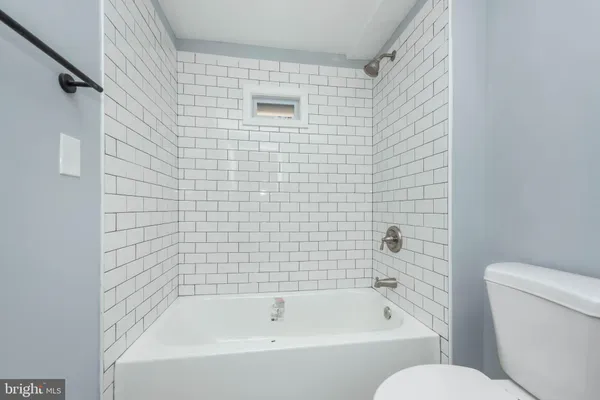 a white bath tub sitting next to a white toilet
