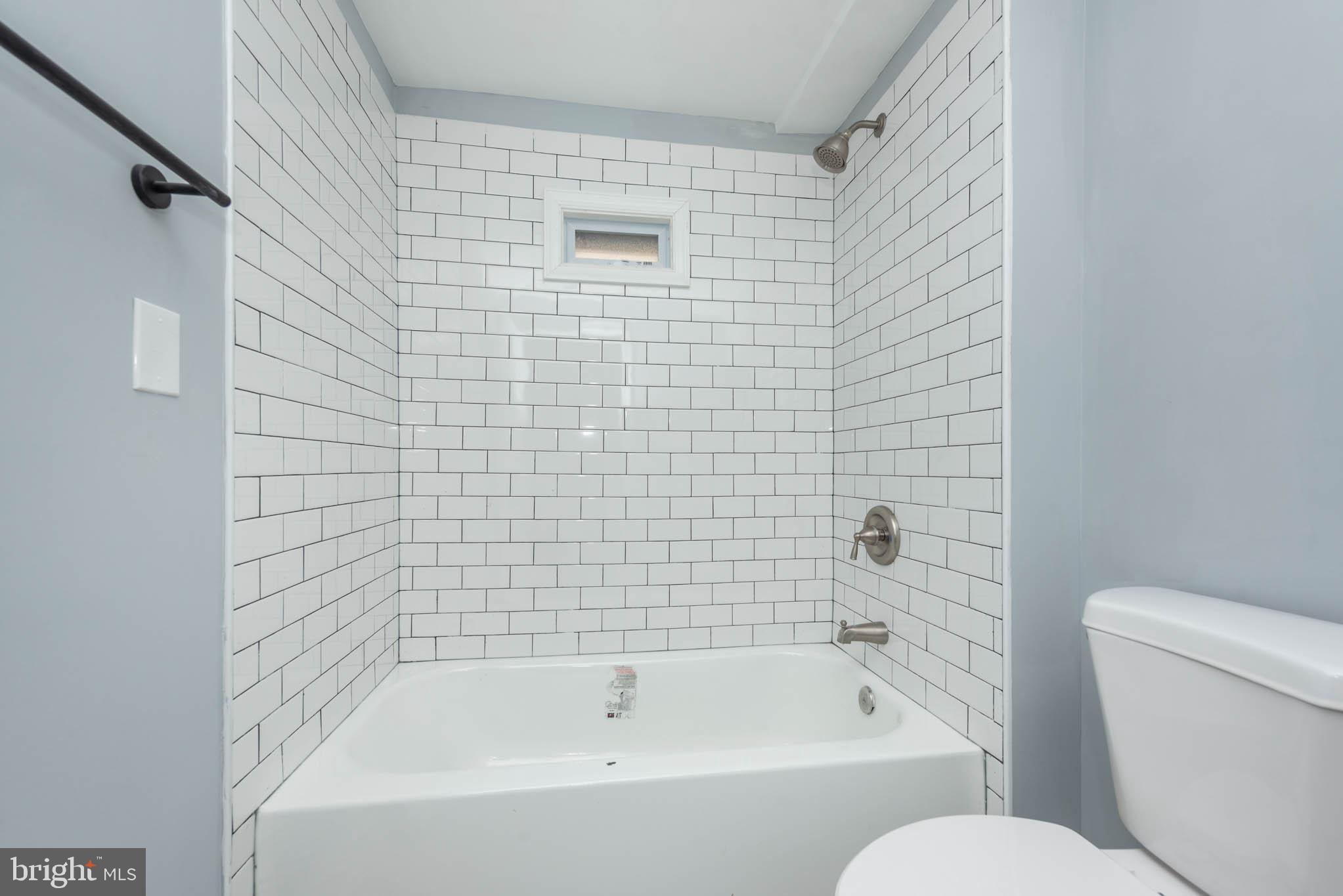 1909 Harlem Avenue Baltimore, MD 21217 - Photo 17 of 27 a white bath tub sitting next to a white toilet