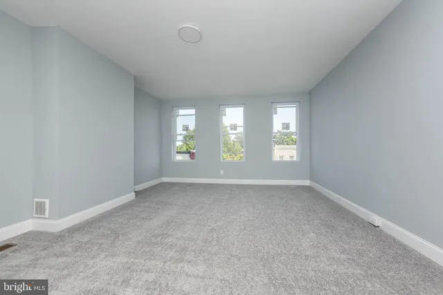 an empty room with windows and entrance