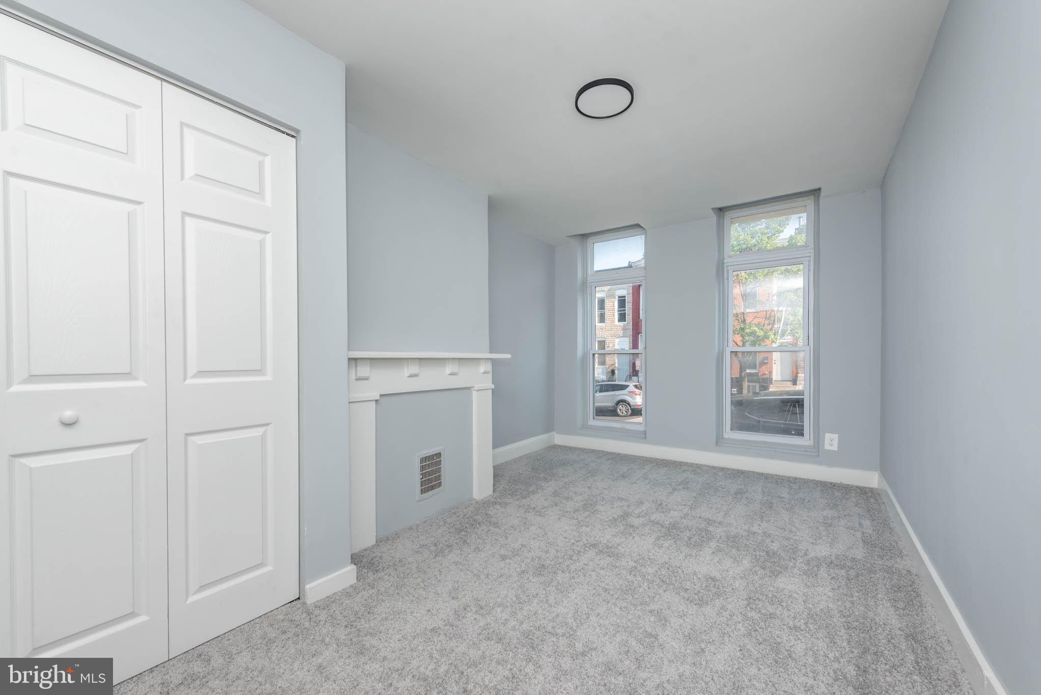 1909 Harlem Avenue Baltimore, MD 21217 - Photo 2 of 27 an empty room with windows and closet