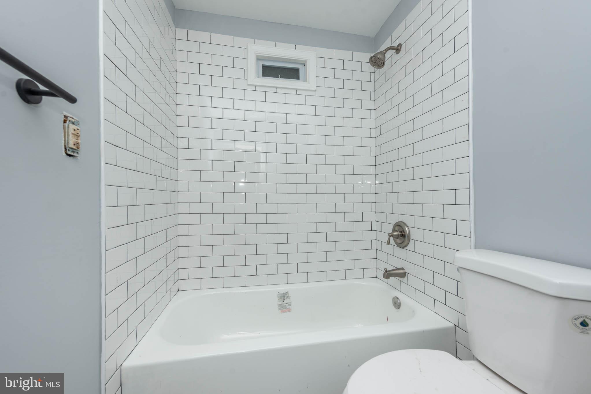 1909 Harlem Avenue Baltimore, MD 21217 - Photo 6 of 27 a bathroom with toilet bathtub and shower
