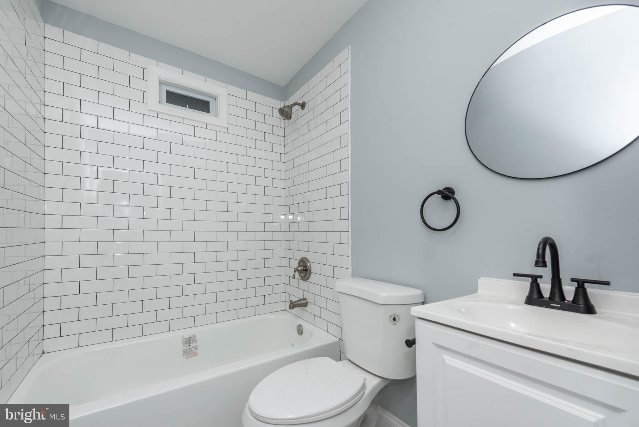 1909 Harlem Avenue Baltimore, MD 21217 - Photo 7 of 27 a bathroom with a sink a toilet and a mirror