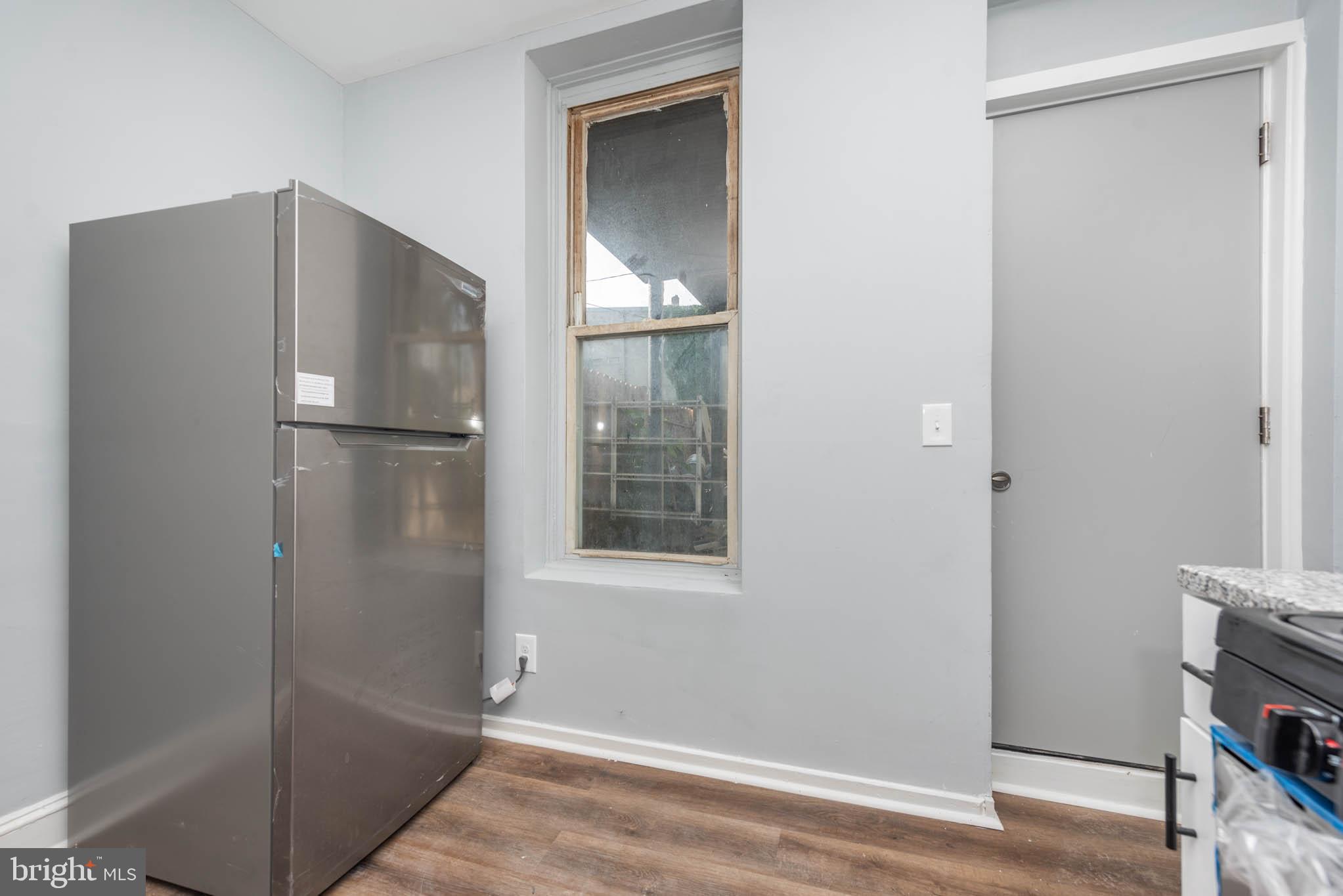 1909 Harlem Avenue Baltimore, MD 21217 - Photo 9 of 27 a white refrigerator freezer and a wooden floor