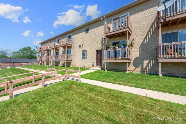 a view of a house with a yard and a porch