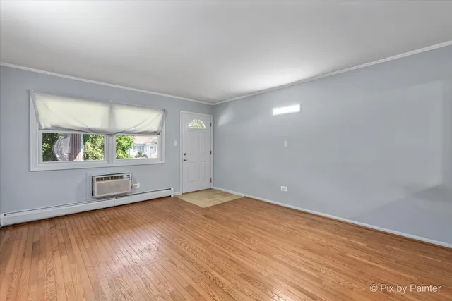 wooden floor in an empty room with a window