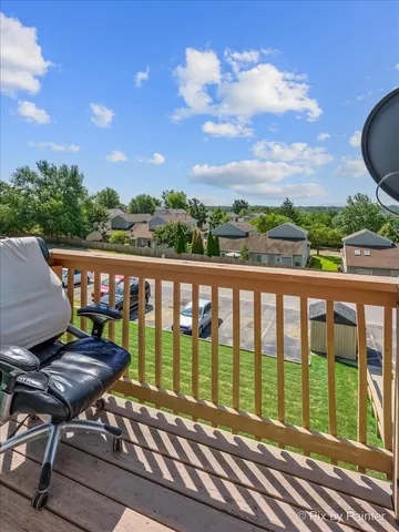 a view of a chairs and table in the balcony