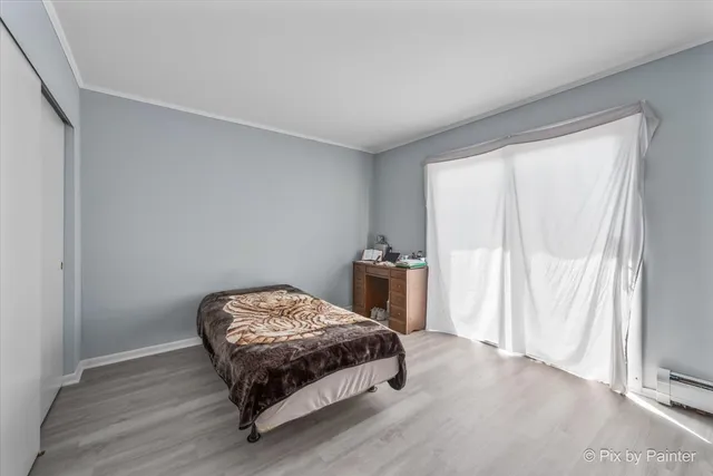 a bedroom with a bed table and a window