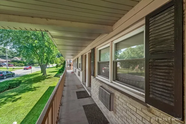 a view of an apartment with a garden and trees