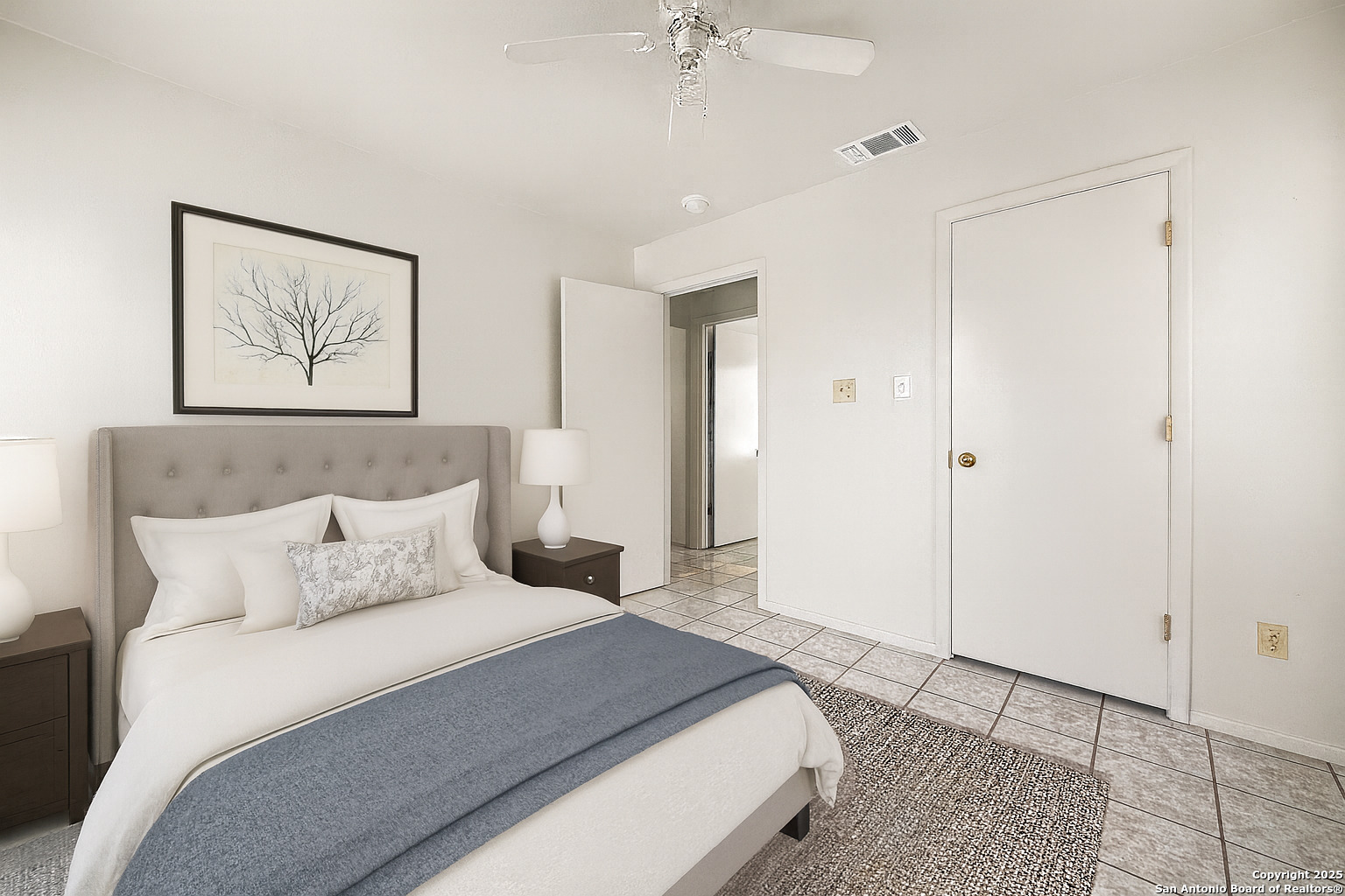 1118 West Goodwin Street, Unit C Pleasanton, TX 78064 - Photo 8 of 13 a bedroom with a bed and a chandelier