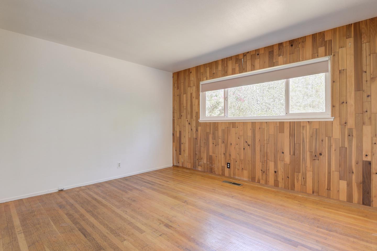 20631 McClellan Road Cupertino, CA 95014 - Photo 6 of 26 an empty room with wooden floor closet and windows