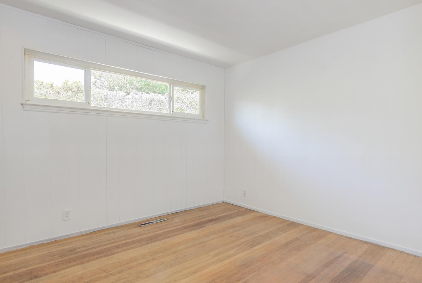 20631 McClellan Road Cupertino, CA 95014 - Photo 9 of 26 an empty room with wooden floor and windows