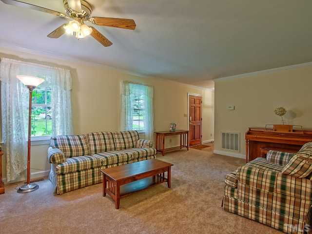 113 Bayleaf Drive Raleigh, NC 27615 - Photo 3 of 23 Living room with huge brink fireplace that is wood burning
