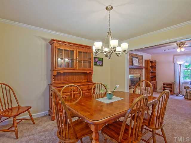 113 Bayleaf Drive Raleigh, NC 27615 - Photo 5 of 23 Dining room with glass doors leading to screened porch and wood deck