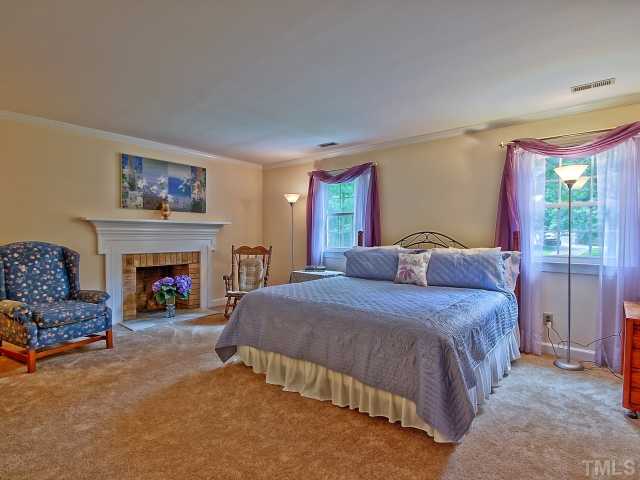 113 Bayleaf Drive Raleigh, NC 27615 - Photo 10 of 23 Master suite has beautiful brick fireplace with oversized wood mantle.