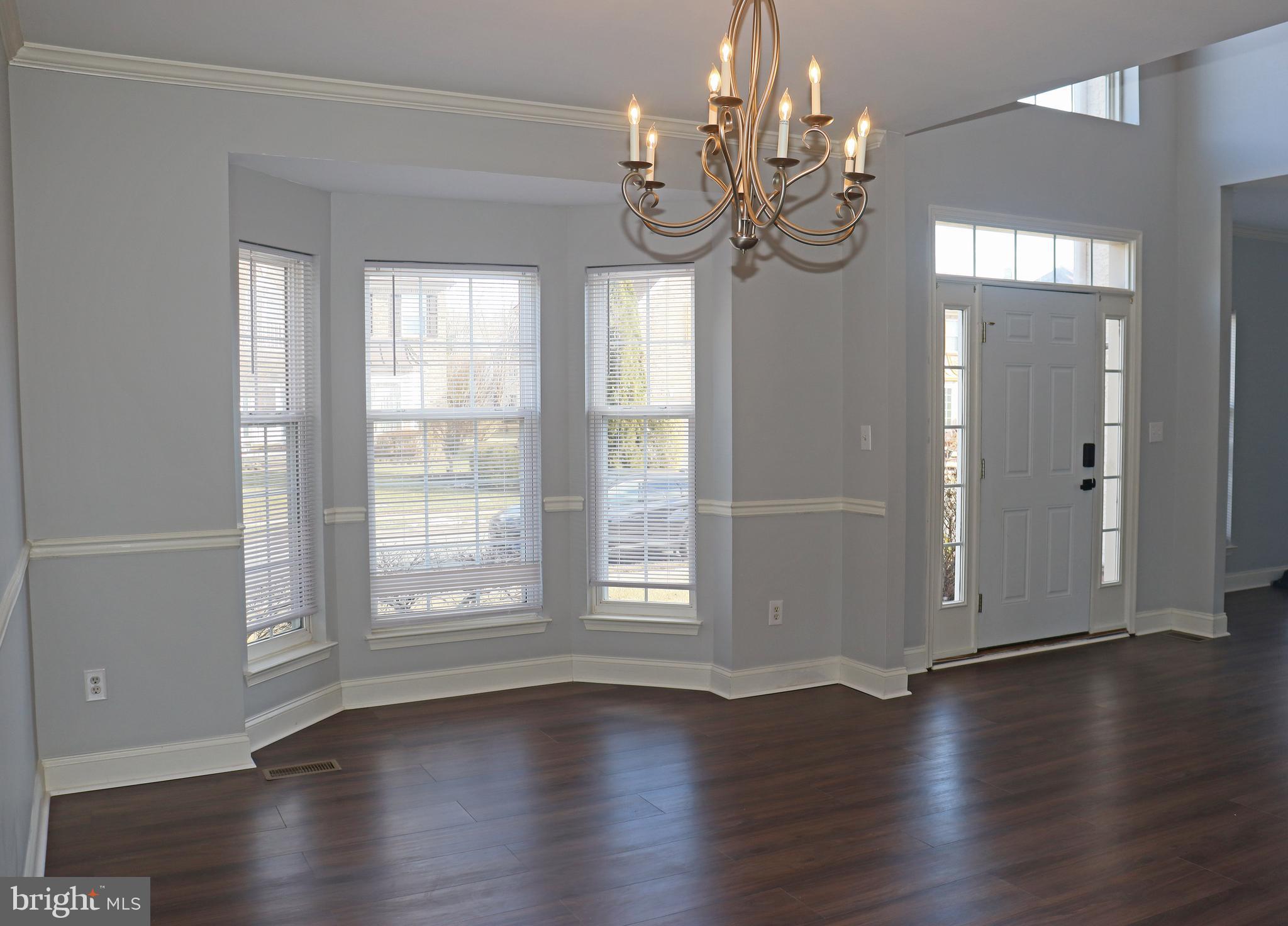 24 Blue Spruce Drive Bear, DE 19701 - Photo 5 of 13 a view of a livingroom with wooden floor and windows
