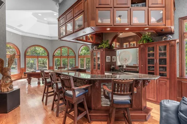 a bedroom with a bed and a large window with outer view