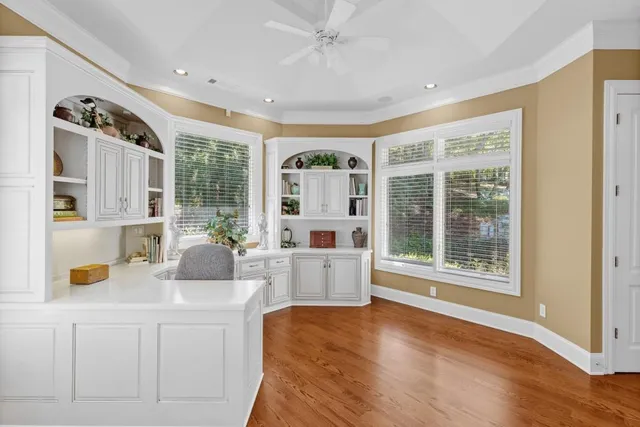 an aerial view of a residential houses with outdoor space and trees