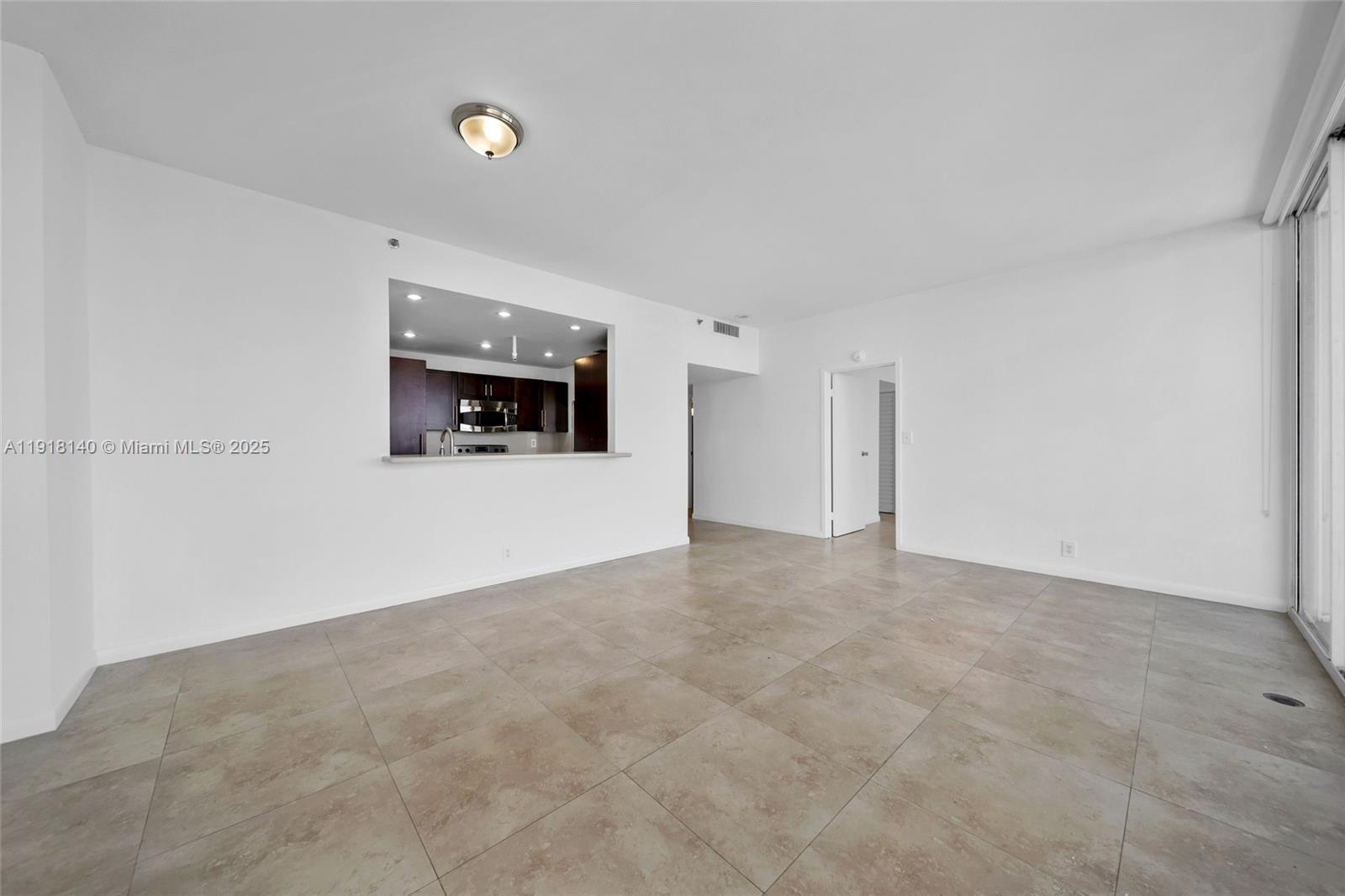 7601 East Treasure Drive, Unit PH215 North Bay Village, FL 33141 - Photo 13 of 40 a view of an empty room with a fireplace and a window