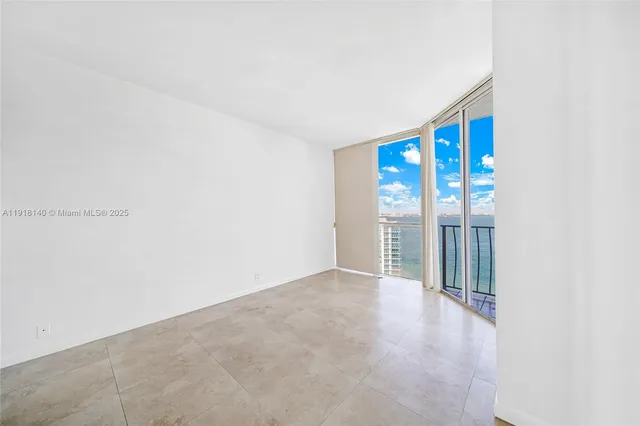 a view of an empty room with glass door