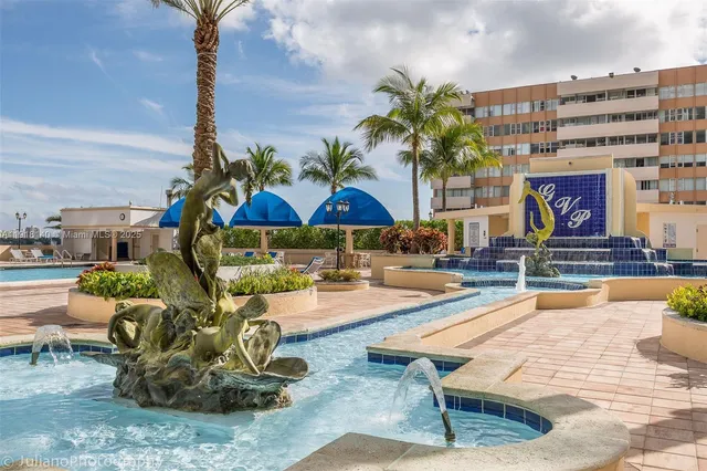 a swimming pool with outdoor seating