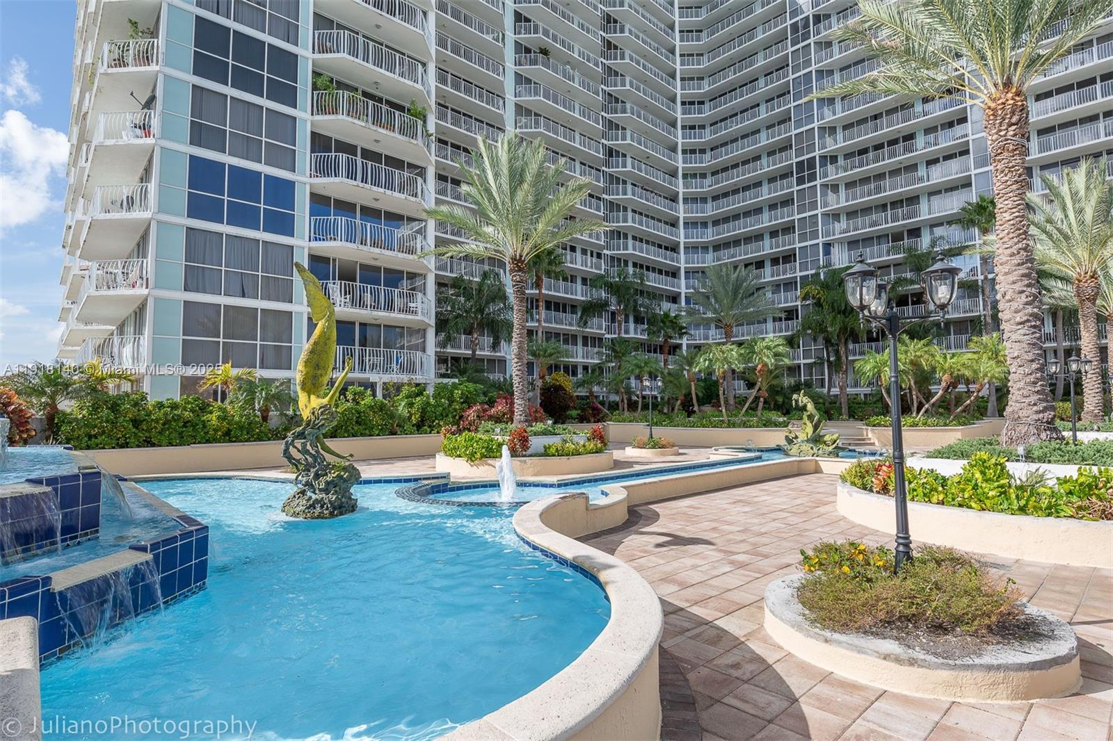 7601 East Treasure Drive, Unit PH215 North Bay Village, FL 33141 - Photo 36 of 40 a view of a building with garden and sitting area