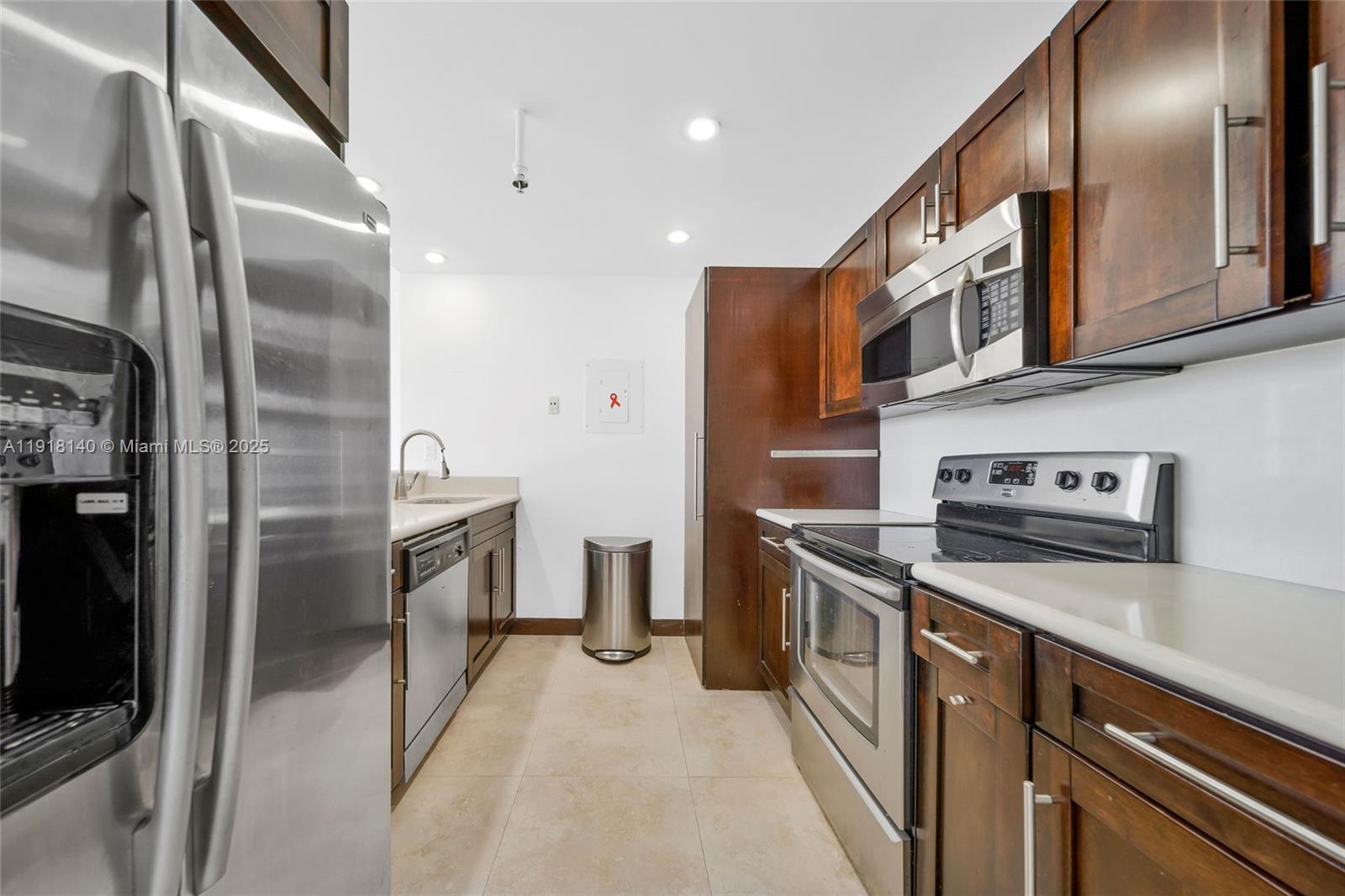 7601 East Treasure Drive, Unit PH215 North Bay Village, FL 33141 - Photo 7 of 40 a kitchen with stainless steel appliances granite countertop a refrigerator a stove and a sink