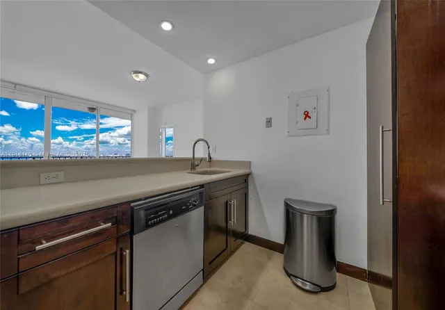a kitchen with a sink and a refrigerator