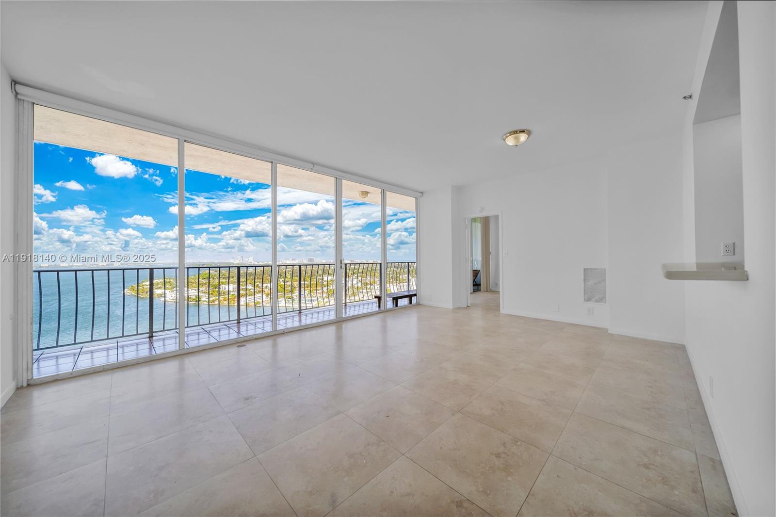 7601 East Treasure Drive, Unit PH215 North Bay Village, FL 33141 - Photo 9 of 40 a view of an empty room with wooden floor and a window