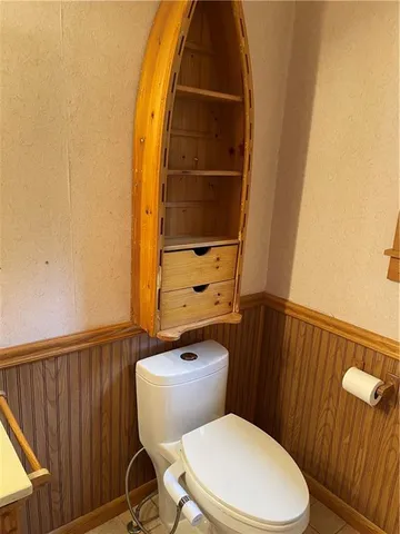 a view of empty room with wooden floor and a fireplace