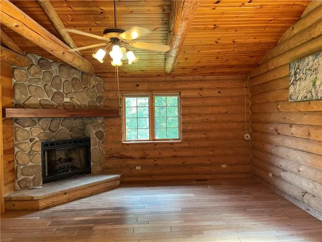 a view of a bathroom with wooden door and shower