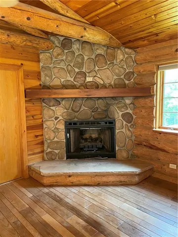 a bathroom with stainless steel appliances wooden floor and next to a window