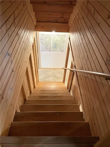 a view of a room with wooden walls