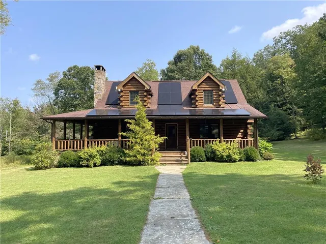 a front view of house with yard and green space