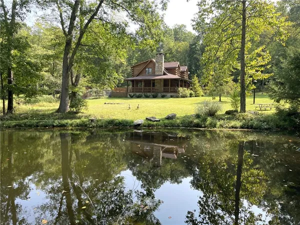 a view of a lake with a house in the background